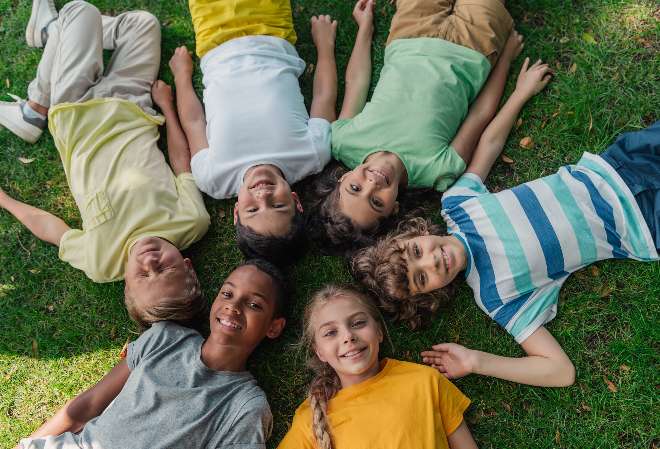 kids lying in field